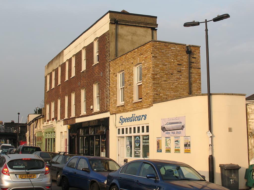 The Speedicars minicab office and Browns of Brockley on Coulgate Street in 2011, with cars parked along the kerb
